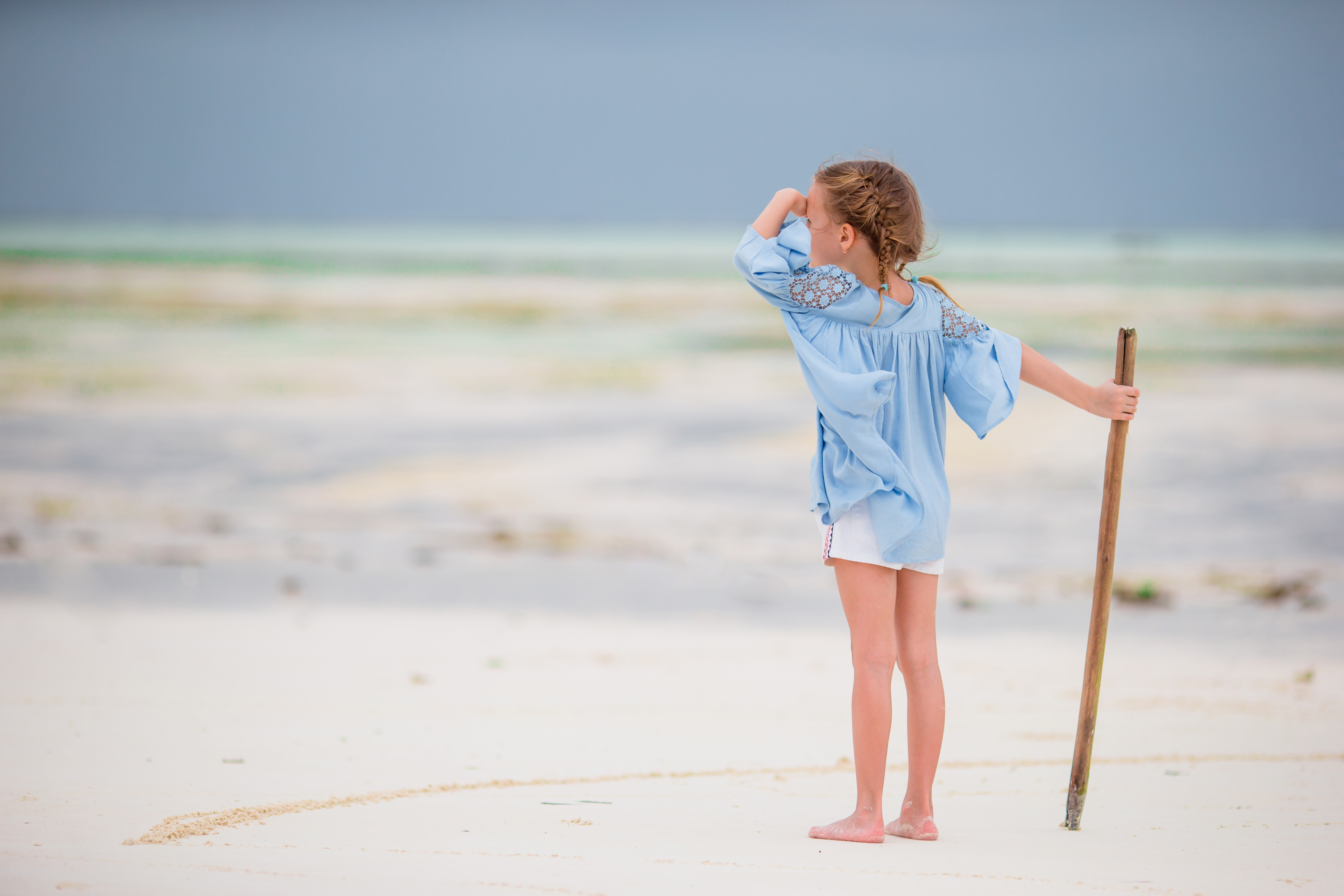 Adorable little girl on beach vacation having fun