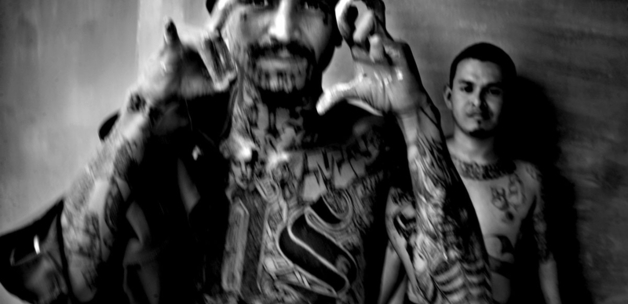 Member of the Mara Salvatrucha shows gang signs inside the Chalatenango prison.